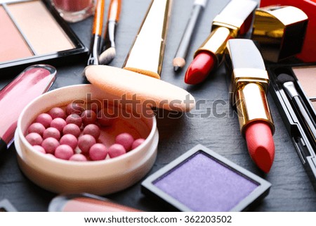 Cosmetics on dark background, closeup