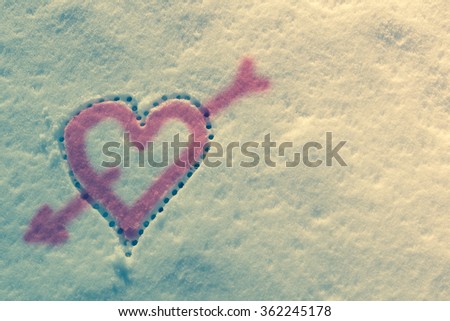 Snow with drown heart shape. Vintage filter applied.