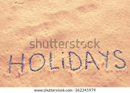 Written words Holidays on a snow field. Hottest Summer filter applied.