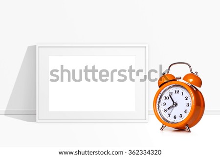 Blank frame and orange alarm clock, interior poster