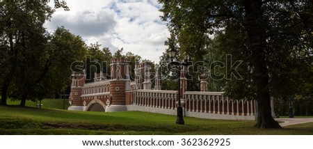 View of the old brick bridge in a Moscow Park. Moscow. Russia. Panorama made from multiple photos.