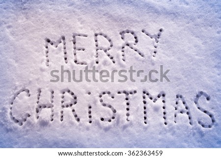 Written words Merry Christmas on a snow field, new year concept. filter applied.