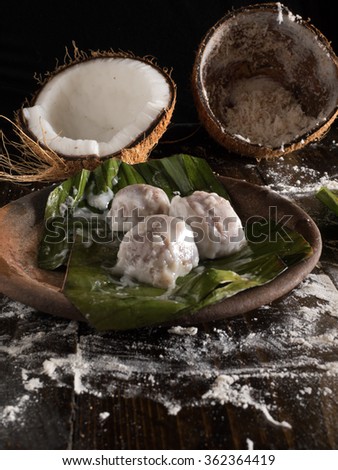 Kuih Koci,a traditional Malaysia pastry,serve on banana leaf,shot from top with wooden background