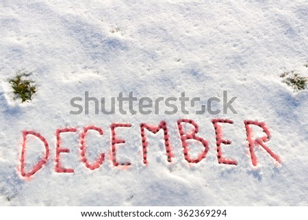 Written words December on a snow field.