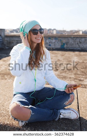 happy young woman with smartphone and headphones