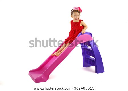 Little girl having fun on slide isolated on white Royalty-Free Stock Photo #362405513