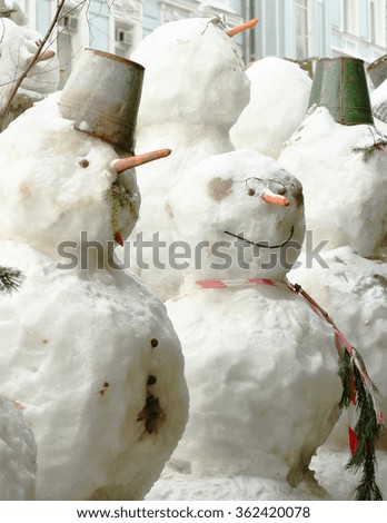 group of snowman in the winter outdoors in northern city 