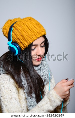 Woman with headphones listening music .Music teenager girl dancing against 
