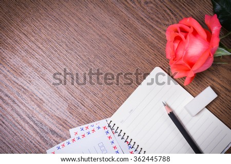Rose and envelope on his desk, Top view with copy space.