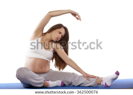 Pregnant woman doing exercises  on white background