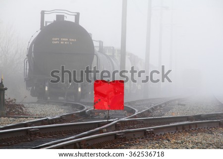 A railway track has been closed, indicated with a red plaque, for maintenance/Railway Track Closed for Maintenance/A railway track has been closed, indicated with a red plaque, for maintenance. 