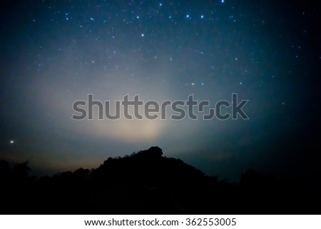 Starry sky and mountain. High level of noise, soft focus
