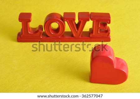 Valentines day. The word love with a red heart  isolated against a yellow background