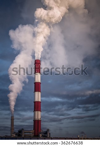Large industrial chimney stack emits toxic pollutants into the sky creating global warming and polluting the natural environment Royalty-Free Stock Photo #362676638