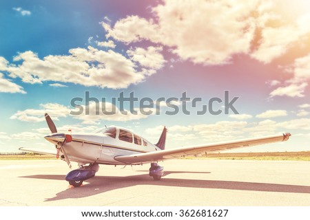 Propeller plane parking at the airport. Sunny day. Royalty-Free Stock Photo #362681627