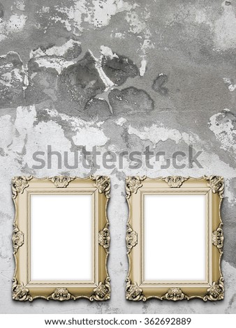 Close-up of two brown Baroque picture frames on weathered concrete wall background