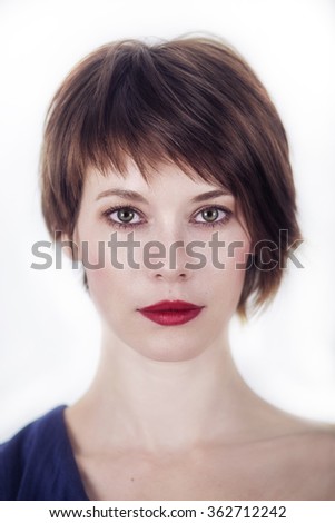 portrait of a young woman with short brown hair on a white background Royalty-Free Stock Photo #362712242