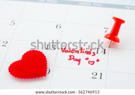 Calender page with a detail of the valentine day with red heart.