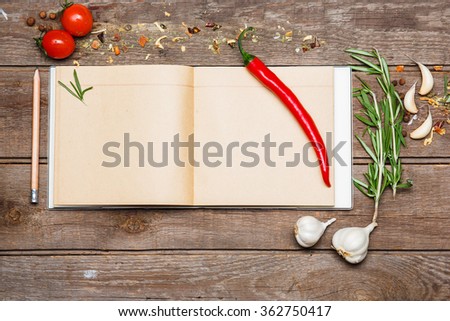 Open blank recipe book on brown wooden background
