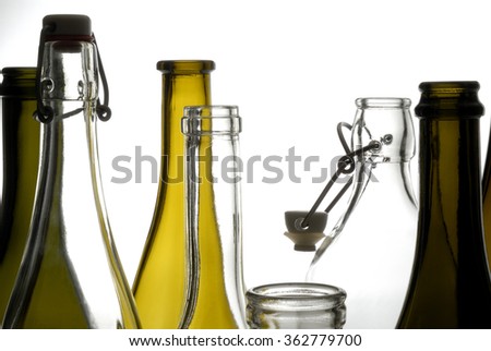 Transparent bottles of different varieties isolated on white.
