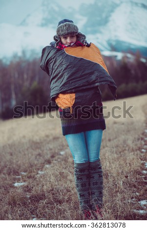 Woman posing outdoor in front of the high mountains