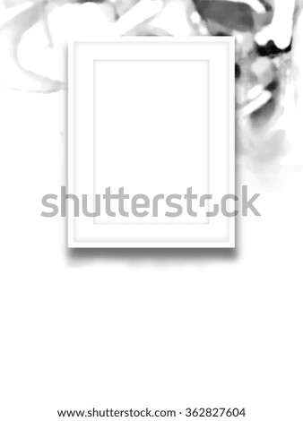 Close-up of one white picture frame on out of focus black abstract painting background