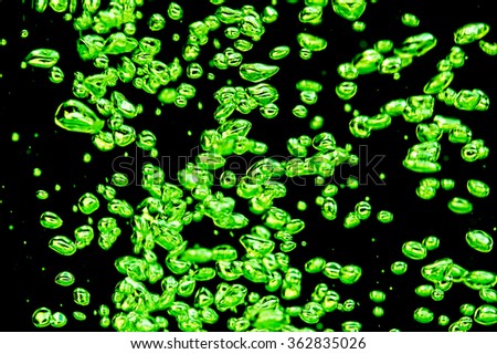 Air bubbles green on a black background.