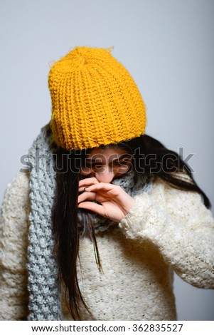 Eastern brunette girl laughs to tears, hipster in winter clothes, isolated studio portrait emotions