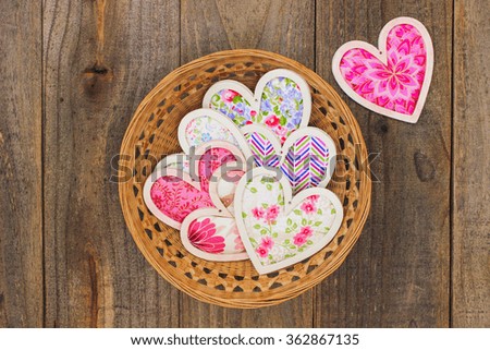 Wicker basket full of country fabric pink and floral Valentine's Day hearts; above view looking down