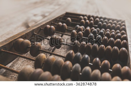 Vintage abacus on wooden background Royalty-Free Stock Photo #362874878