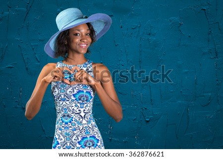 Beautiful african woman making a heart shape with her hands