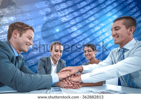 Business team celebrating a good job against stocks and shares