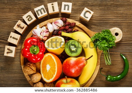 Vitamin C in fruits and vegetables. Natural products rich in vitamin C as oranges, lemons, dried fruits rose, red pepper, kiwi, parsley leaves, garlic, bananas, pears, apples, walnuts, chili. Royalty-Free Stock Photo #362885486