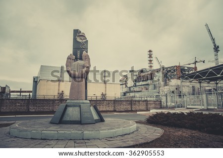 The monument to the liquidators of the Chernobyl accident on the background of the fourth unit of NPP, Pripyat Royalty-Free Stock Photo #362905553