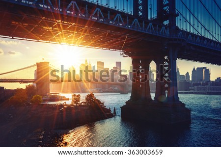 New York City - beautiful sunset over Manhattan bridge with Manhattan and Brooklyn bridge 
