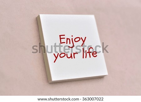 Text enjoy your life on the short note texture background