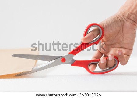 Woman hand holding red scissors  and letter 