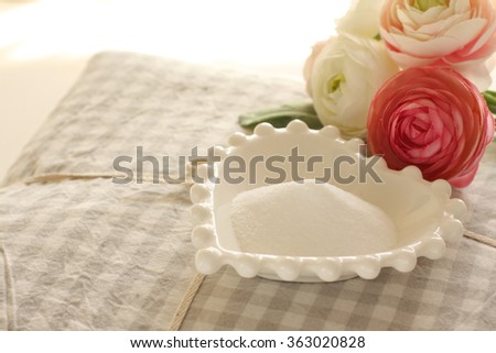 bed sheet and artificial flower with soda for cleaning image