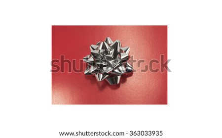 red holiday paper with silver bow isolated on white background
