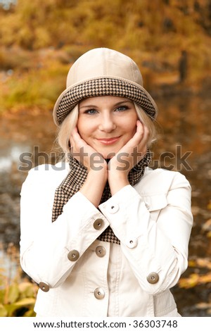 close-up Picture of a young elegant happy woman in a casual clothes and in autumn park