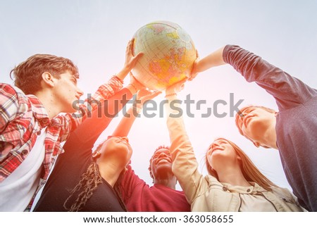 Multiracial Teen Couple Holding Globe Map - stock Royalty-Free Stock Photo #363058655