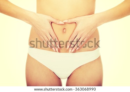 Woman with hands on belly.