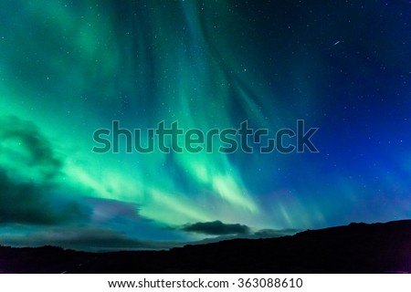 Aurora at night over the land as a background Royalty-Free Stock Photo #363088610