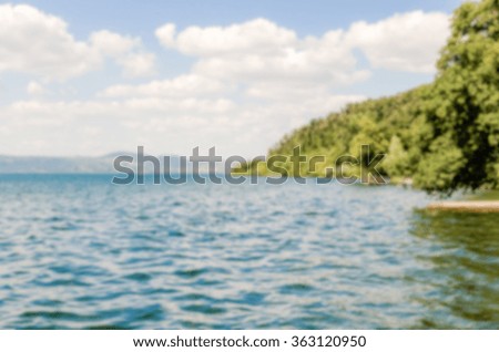 Defocused background with view over Bracciano Lake, Italy. Intentionally blurred post production for bokeh effect