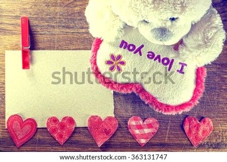 Valentines Day. Teddy Bear Loving cute with red hearts sitting alone. Vintage. Retro romantic styled on wooden background. Copyspase