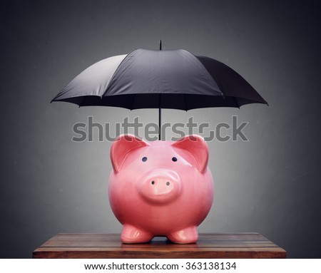 Piggy bank with umbrella concept for finance insurance, protection, safe investment or banking Royalty-Free Stock Photo #363138134