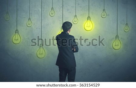 businessman with hanging lighting bulbs