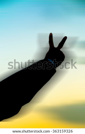 Silhouette of business man hand show two fingers at sunset background