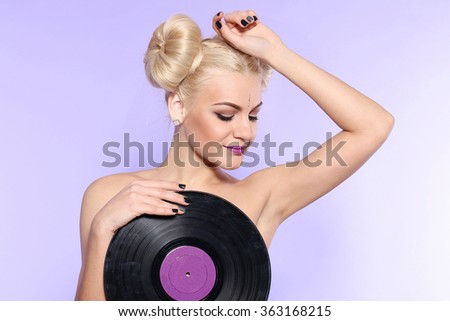 Glamorous pin-up girl holding vinyl LP 