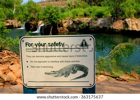 warning sign of crocodiles in the water Royalty-Free Stock Photo #363175637